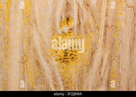 Warm aged wood displays rich grain and vibrant yellow accents against dark backdrop. textured surface evokes feelings of heritage and craftsmanship, s Stock Photo