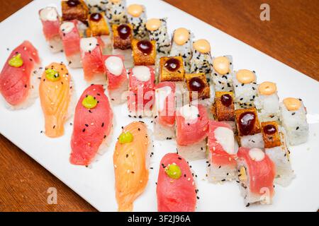 A close-up of a platter filled with assorted sushi and nigiri Stock Photo