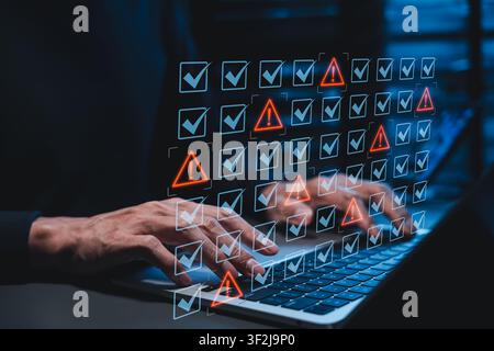 Cyber security risk compliance audit and digital data vulnerability warning alert system concept. developer typing on laptop computer to detect Stock Photo