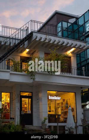 A renovated house-style cafe under a red-tinted sunset sky in Itaewon, Seoul. Stock Photo