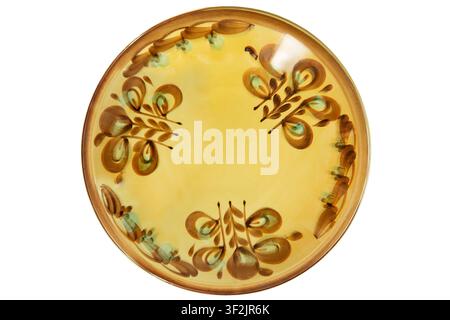 Yellow painted large ceramic dish isolated on white background Stock Photo