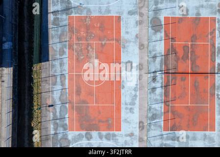 Empty outdoor multi sport facility showing signs of wear and tear from above Stock Photo