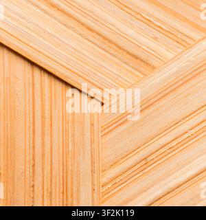 Warm-toned wooden surface displays meticulously crafted angled cross pattern of light wood planks. textured grain evokes feelings of serenity and soph Stock Photo