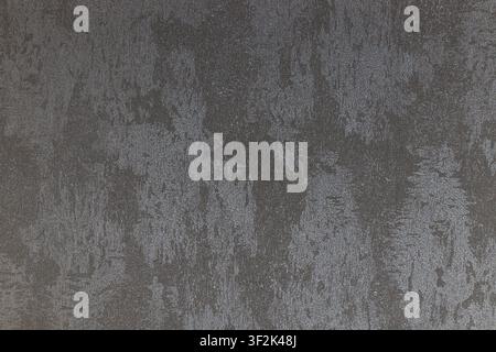 Grunge wallcovering surface in deep gray tones with weathered texture and rugged material detail. Stock Photo