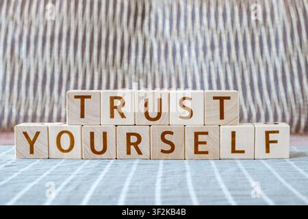 motivational phrase Trust Yourself made of letters on wooden cubes Stock Photo