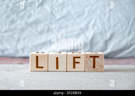 motivational word Lift made of letters on wooden cubes Stock Photo