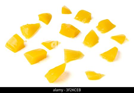 Canned mango cube pieces in syrup isolated. Canned yellow fruits dessert, tinned chopped mango, orange peeled bits on white background Stock Photo
