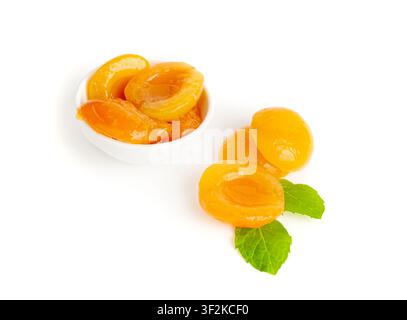 Canned Peaches in Bowl Isolated, Apricot Halves in Syrup, Yellow Fruit Dessert, Tinned Nectarine Compote, Orange Peeled Peache Slices on White Backgro Stock Photo
