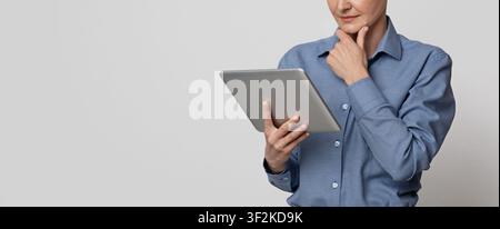 Modern Technologies For Business. Thoughtful Businesswoman Using Digital Tablet, Website Banner Stock Photo