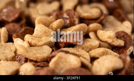 Chocolate cereal flakes closeup, macro rice crispy breakfast. Corn and choco cornflakes detailed photo, breakfast caramel cereal pops mockup with sele Stock Photo