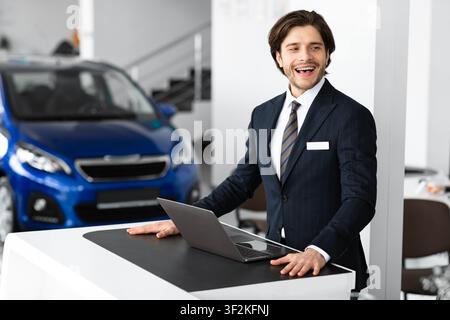 Car Sales Manager Posing In Luxury Dealership Office Stock Photo