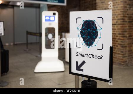 Automated biometric security kiosk and smart check sign at airport terminal Stock Photo