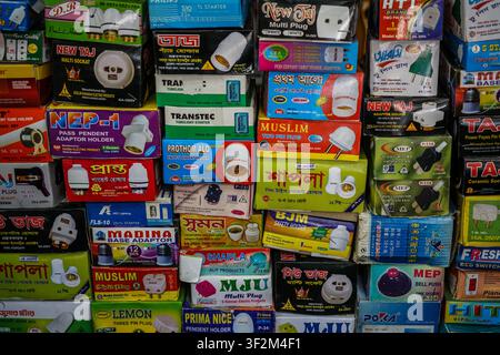 The image shows a close-up, full frame view of various rectangular retail boxes for electrical products, including multi plugs, adaptors, and bulb hol Stock Photo