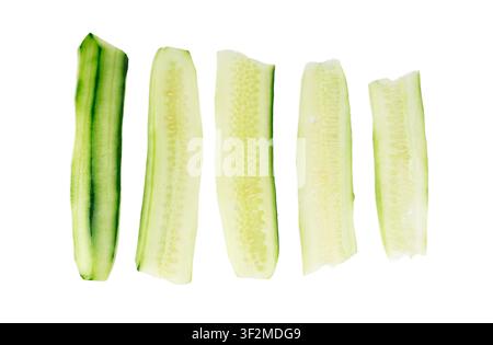 Cucumber cut isolated, cucumber thin strips, ribbons, green vegetable cuts for salad isolated, healthy natural plant pieces, macro cucumbers slices on Stock Photo