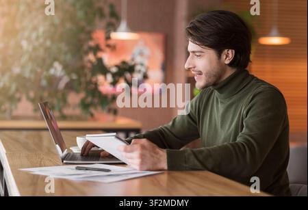 Journalist working on new article online at cafe Stock Photo