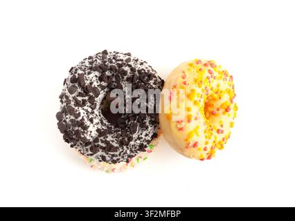 Doughnuts Pile Isolated, Chocolate Brown, Yellow and Pink Donuts, Donuts Stack with Multicolored Sprinkles, Doughnuts on White Background Stock Photo