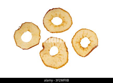 Dry apple slices isolated. Dried apple chips, healthy fruit snack top view, dehydrated gourmet rings, crunch pitted sweet pear chips on white backgrou Stock Photo