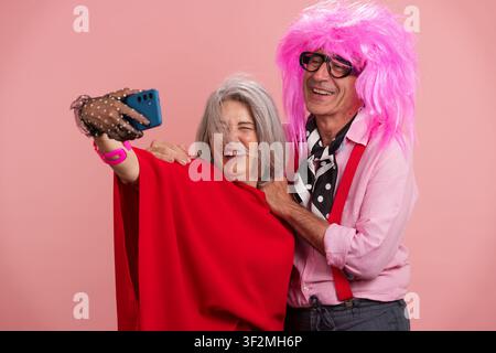 Mature couple having fun taking selfie embracing active aging Stock Photo
