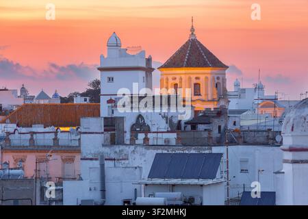 View of historic rooftops and church architecture in Cadiz, Andalusia, Spain, with whitewashed buildings and traditional urban skyline. Stock Photo