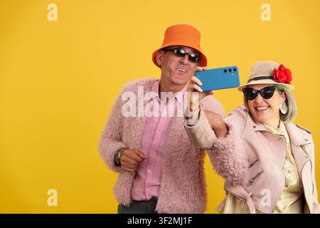 Mature couple taking selfie celebrating active aging Stock Photo