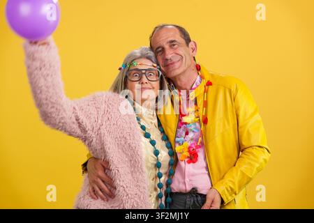 Active mature couple having fun celebrating life with balloon Stock Photo