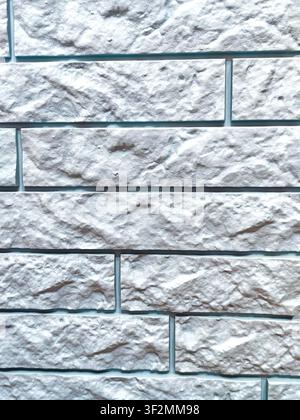 High resolution close-up of a white decorative stone brick wall with realistic rough texture and horizontal masonry pattern. Ideal seamless background Stock Photo