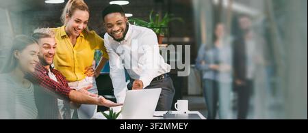 Smiling Black Man And Three Colleagues Working Together At Office, Business Concept Stock Photo