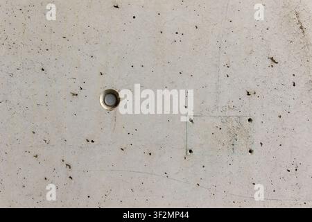 Raw light grey exposed concrete wall texture background with formwork tie rod holes and subtle seams, smooth architectural concrete surface for modern Stock Photo