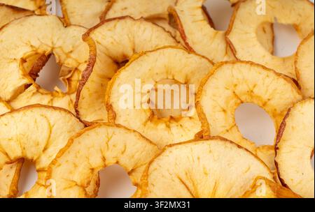 Dry apple slices pattern. Dried apple chips textured background, healthy fruit snack close up, dehydrated gourmet rings, crunch pitted sweet pear chip Stock Photo