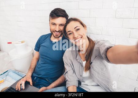Happy young couple sitting in new apartments Stock Photo