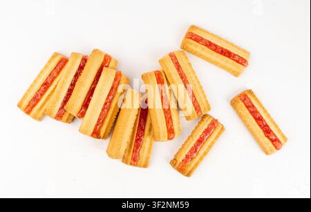 Shortbread sticks with a jam strip isolated, biscuit cookies, rectangular pieces with fruit marmalade or jelly on white background Stock Photo
