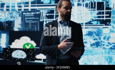 Entrepreneur presenter hosting live conference to highlight AI usage in business growth, demonstrating the use of neural networks system and machine learning. Fintech event. Camera A. Stock Photo