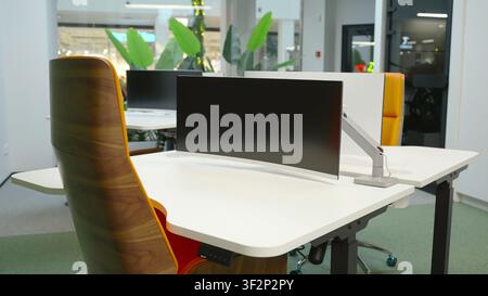Contemporary office interior with central monitor and desk Stock Photo