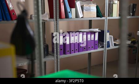 Office storage shelves with purple binders and documents in a tidy archive room Stock Photo