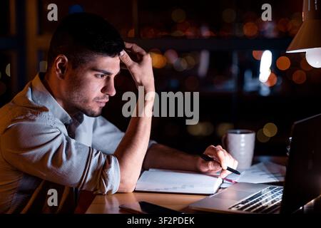 Concentrated Businessman Working On Laptop Sitting In Office Stock Photo
