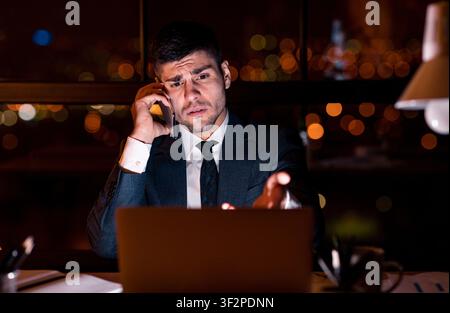 Displeased Businessman Calling To Technical Support Sitting In Modern Office Stock Photo