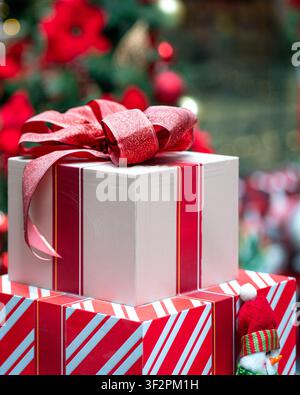 Box Christmas presents wrapped and tied with red ribbon. Holiday season concept. Stock Photo