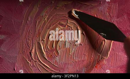 Pink paint spread with palette knife on textured surface Stock Photo
