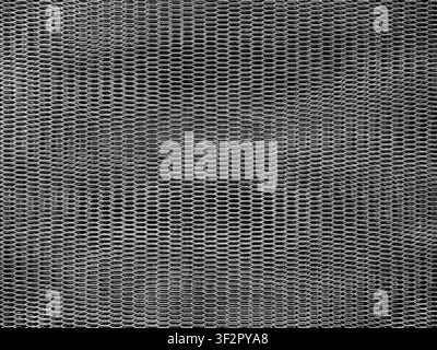 Abstract black metal mesh texture with hexagonal pattern. Industrial background featuring geometric design, metallic surface, and seamless grid, ideal Stock Photo