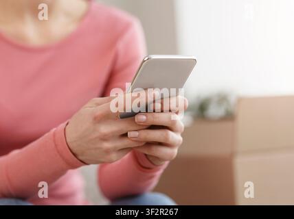 Unrecognizable woman using cellphone for online shopping Stock Photo