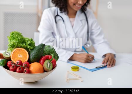 African doctor dietologist taking notes in her office Stock Photo