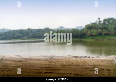 empty bamboo table with blurry lake background Stock Photo
