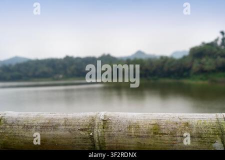 empty bamboo table with blurry lake background Stock Photo