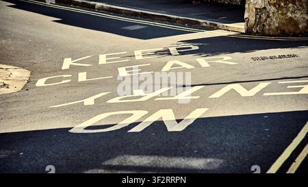 Keep clear and no entry painted on narrow steep road,UK Stock Photo