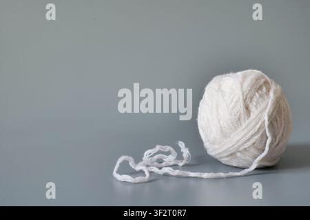 White Ball of Knitting Yarn on Gray Background Stock Photo