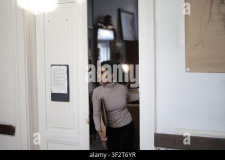 Young black woman with glasses looking back in doorway Stock Photo