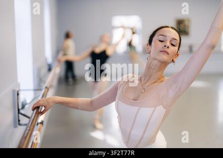 Ballerinas rehearsing ballet movements in dance studio Stock Photo