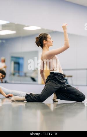 Young female dancer rehearsing in ballet studio Stock Photo