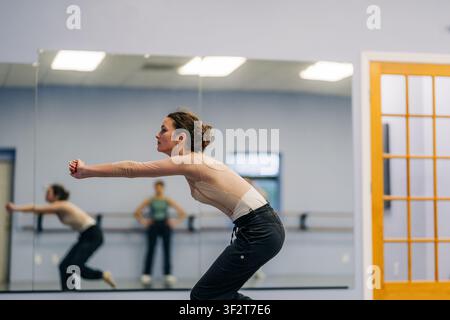 Female dancer practicing movement in studio rehearsal Stock Photo