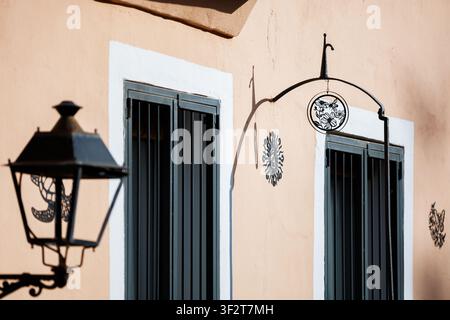 Vintage Lantern and Decorative Metal Details on a Terracotta Facade Stock Photo
